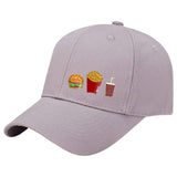Milkshake Emaille Pin samen met een hamburger en frietjes emaille pin op een grijze cap