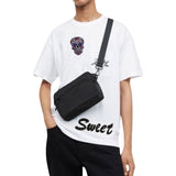 Sweet Tekst Strijk Strass Patch samen met een sugar skull strijk embleem op een wit t-shirt