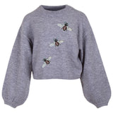 Drie maal de Bij Bijen Paillette Strijk Embleem Patch op ee ngrijze sweater