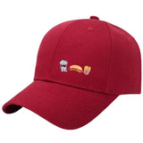 Hotdog Emaille Pin samen met een popcorn en bakje friet pin op een rode cap
