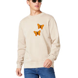 Twee maal de Vlinder Strijk Applicatie Embleem Patch Oranje op een beige sweater