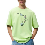 Bloesem Bloemen Tak Strijk Embleem Patch Wit Oranje Groen op een lichtgroen t-shirt