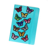 Vlinder Strijk Embleem Patch Blauw samen met nog elf ander kleuren van deze patch op de voorzijde van een agenda