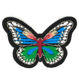 Vlinder patch met groen blauwe vleugels en vele kleine witte oogjes
