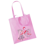 Flamingo Aloha Tekst Strijk Applicatie op een roze linnen tas
