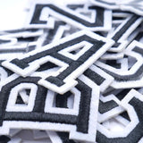 Zwarte Alfabet Letters Met Witte Rand Strijk Patches