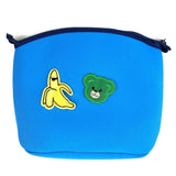 Teddy Beer Strijk Embleem Patch donker groen samen met een banaan patch op een blauwe toilettas