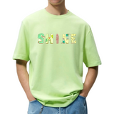 SHINE Tekst Strijk Applicatie op een groen t-shirt