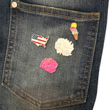 USA Amerika Emaille Pin samen met drie andere pins op de zak van een spijkerjasje